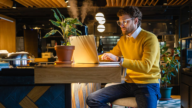 Man working on a laptop in a cafe